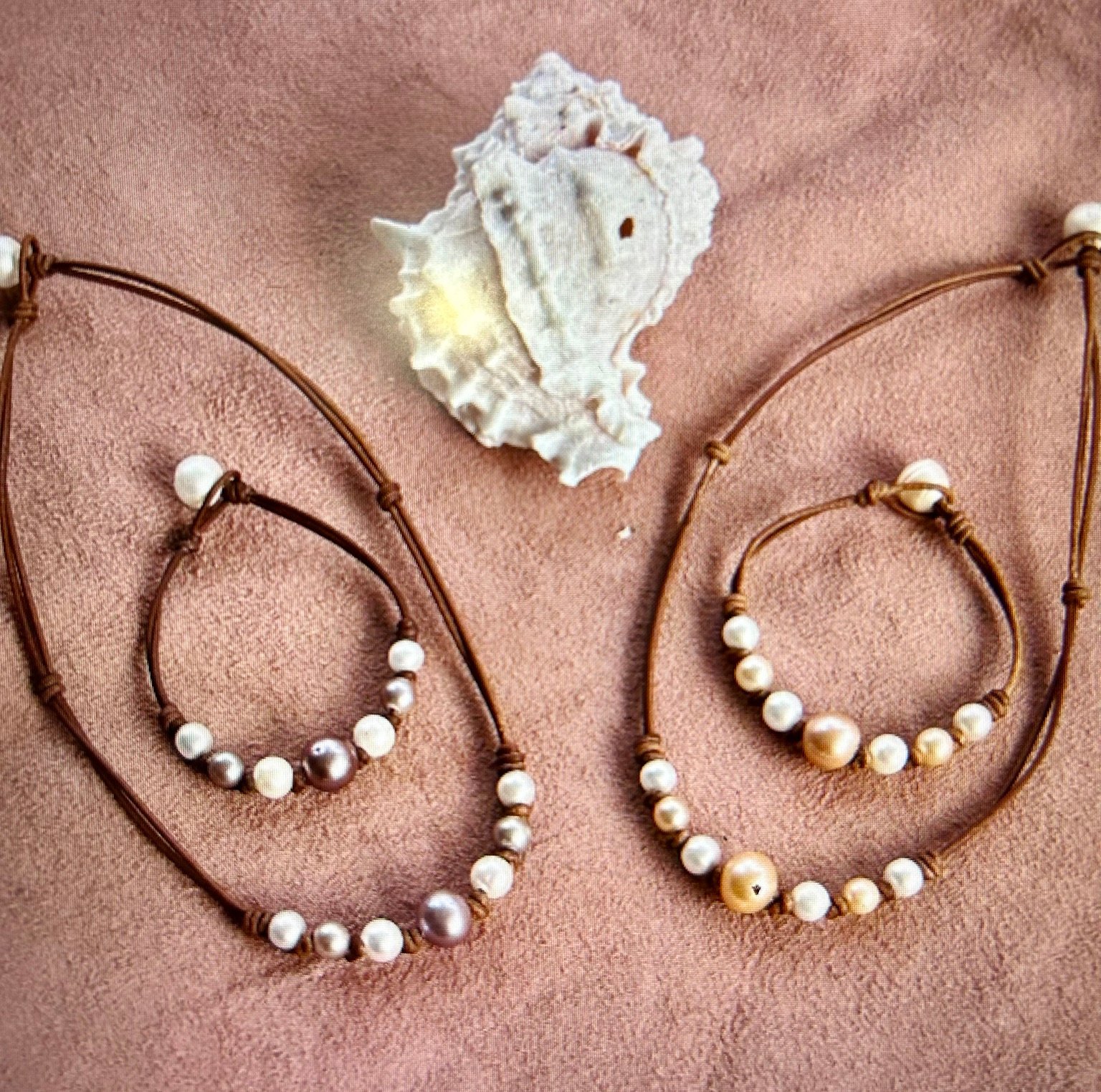 Handmade pearl necklaces and bracelets on natural leather