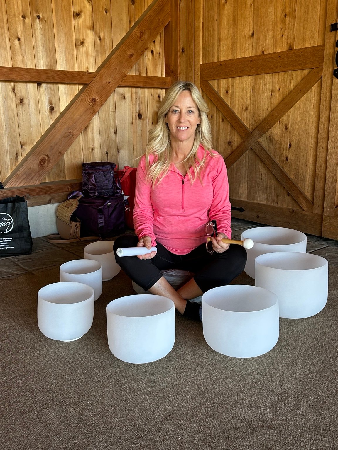 SueZ seated with crystal singing bowls